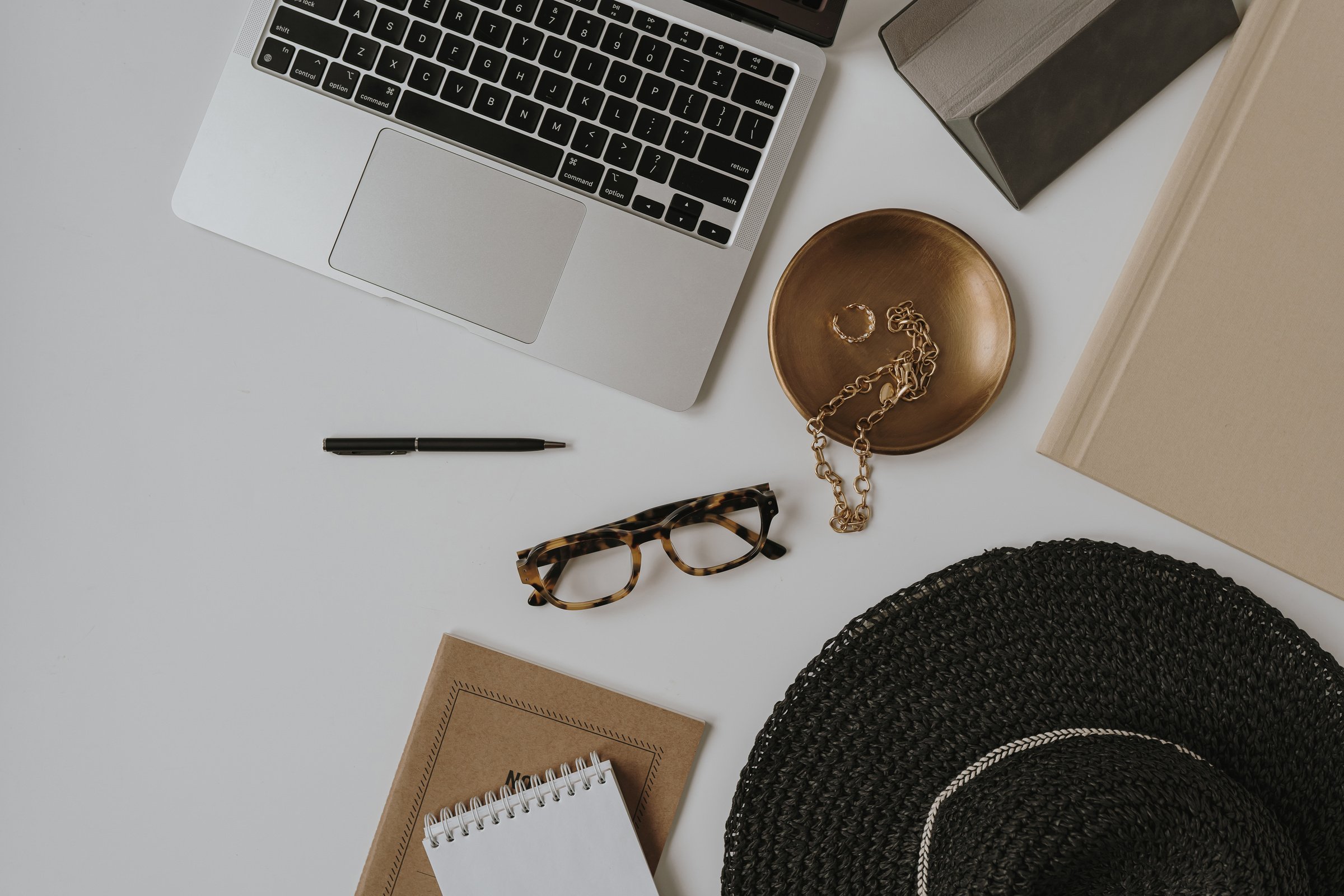 Laptop, Jewelry, and Eyeglasses in Workplace Table